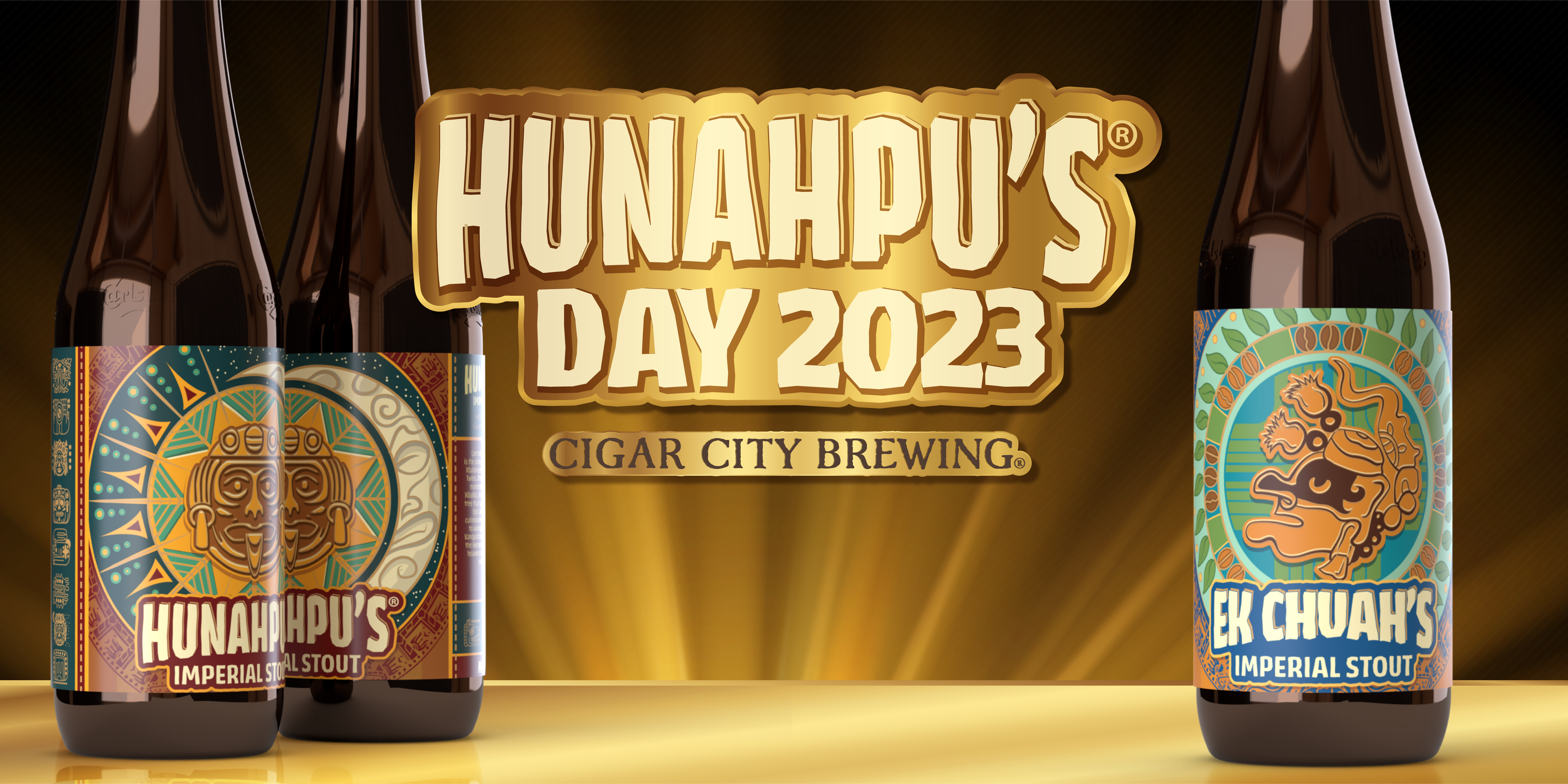Bottles of Hunahpu's Imperial Stout 2023 next to a bottle of 2023 Ek Chuah's Imperial Stout with text that says Hunahpu's Day 2023 and Cigar City Brewing.